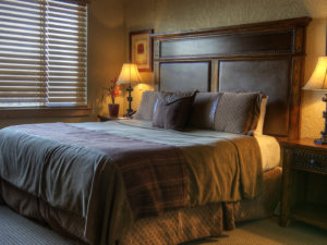 Bedroom with dark wooden bed and furniture
